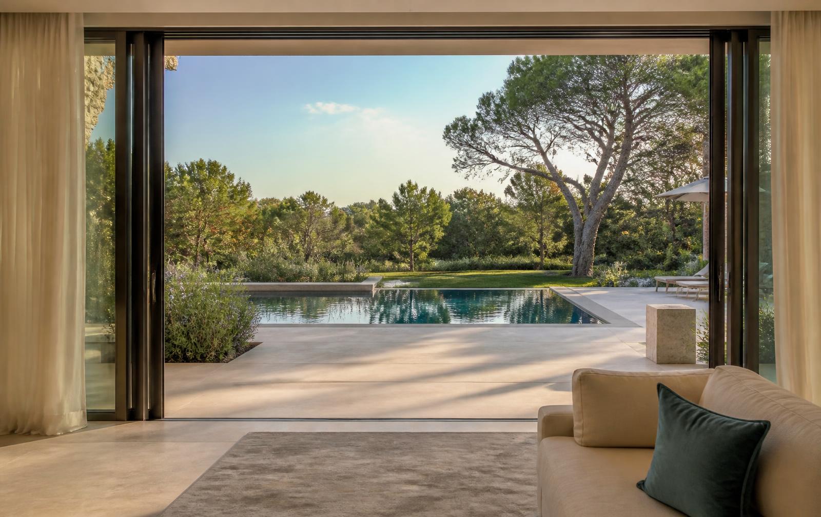 View from the Villa A68 living room toward the terrace, pool and garden